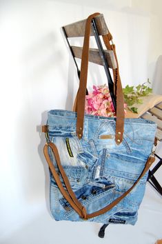 This high quality bag made from recycled denim is perfect for your every days. You can wear it with casual jeans and sneakers but also with an elegant dress and high-heels. Carrying everything what you need in a busy day is going to be easy with that handmade bag. The bag is made from recycled, high-quality denim jeans in an eco-friendly way with love. Of course, the denim was cleaned properly. Denim makes these items durable. This bag is exquisite for you if you care about the environment and nature. You can find twof unctional opened pockets in side. Closing the whole bag is possible with a zipper. To makeit more aesthetic, I used recycled shirt inside. The straps are real leather which can possess the bag. Size: Top lenght: 35 cm/ 13,78 in Height: 40 cm / 15,75  in Depth: 3 cm / 1,18 in Trendy Upcycled Tote Bag, Trendy Recycled Denim Bags For Daily Use, Trendy Recycled Denim Shoulder Bag For Daily Use, Trendy Recycled Denim Shoulder Bag For Everyday Use, Casual Denim Shoulder Bag With Leather Handles, On-the-go Denim Bags With Leather Handles, Trendy Upcycled Denim Blue Bags, Everyday Denim Patchwork Shoulder Bag, Denim Patchwork Bag For Everyday Use