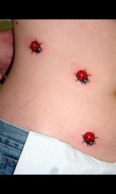 two ladybugs on the side of a woman's stomach