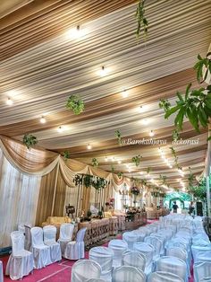 the banquet hall is decorated with white linens and greenery