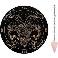 a black and gold zodiac sign with two skulls on the front, and a pink stone pendant in the middle