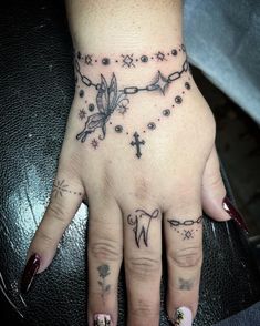 a woman's hand with tattoos on it