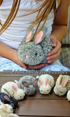 a girl is holding her stuffed animal bunny with four other bunnies in front of her