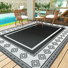 a black and white area rug sitting on top of a wooden floor next to a swimming pool