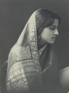 an old photo of a woman wearing a veil