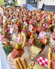 a table topped with lots of different types of food on top of glass bowls filled with fruit