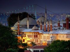 an image of a building that is lit up in the night time sky with lights on it