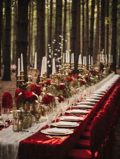 a long table is set up with red and white linens, candles, and flowers