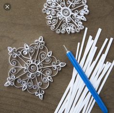 the paper snowflakes are being made with scissors and yarnsticks to make them look like snowflakes