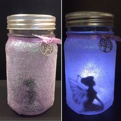 two mason jars with fairy dust inside each jar and one has a silhouette of a girl on it