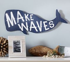 a wooden sign that says make waves on the side of a shelf next to other items