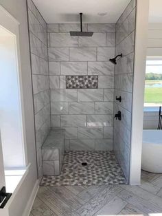 a walk in shower sitting next to a bath tub