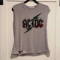 Ac/Dc Distressed Cutoff Style Tee With Distressed Style ‘Rips’ On Tee For A Trendy Distressed Look. In Excellent Never Worn Condition. Make An Offer Or Bundle For Discount! Casual Ripped Tank Top For Summer, Spring Stretch Distressed Tops, Summer Grunge Ripped Tops, Grunge Ripped Tops For Summer, Ripped Grunge Tops For Summer, Casual Sleeveless Ripped Top, Ripped Sleeveless Summer Tops, Summer Ripped Stretch Top, Summer Stretch Ripped Tops