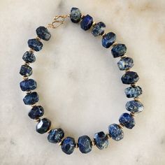 A Chunky Collar of rich Lapis Lazuli with a snake clasp. Lapis lazuli has been associated with royalty, strength and courage, wisdom and intellect, friendship, and truth. In ancient Egypt, it was powdered and worn around the eyes to improve eyesight, and some today consider it an aid to balancing the brow chakra, which influences vision and hearing. Brass beads in between each stone bead are plated in 18K gold. 16" long. All orders over $50 ship for free within the USA. All orders usually ship within 24 hours from NYC. Artisan Lapis Lazuli Hand-strung Jewelry, Artisan Hand-strung Lapis Lazuli Jewelry, Spiritual Kyanite Gemstone Beads Jewelry, Eye Sight Improvement, Fine Jewellery Necklace, Ancient Egypt, Ring Bracelet, Lapis Lazuli, Stone Beads