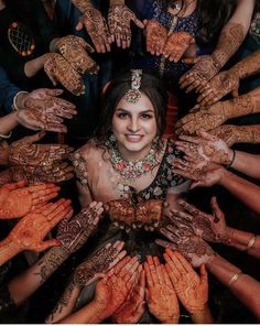 a group of people with their hands covered in hendikes and smiling at the camera