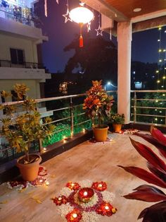 a balcony decorated with flowers and candles for diwaling