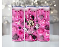 three pink mickey mouse lighters sitting on top of a table