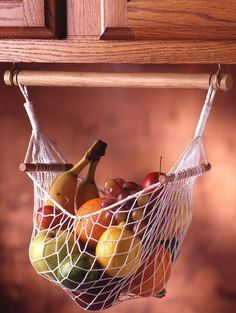 a fruit bag hanging from the side of a wooden cabinet