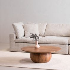 a living room with a white couch and wooden coffee table