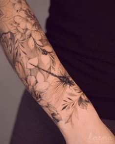 a woman's arm with flowers on it