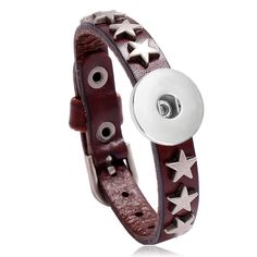 a brown leather bracelet with silver stars on the side and a button in the middle