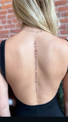 the back of a woman's neck with writing on it