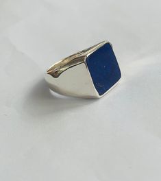 Make:  925 Sterling Silver Stone:  Lapislazuli  Stone Size 14x14 This square lapis ring handmade in Afghanistan offers a unique blend of craftsmanship and natural beauty. Expert artisans meticulously handcraft the ring, ensuring attention to detail and quality. This stone is sourced directly from the mines of Afghanistan, where it is carefully selected for its color and quality. The setting of the ring is crafted from sterling silver, providing a sturdy yet elegant frame for the lapis lazuli. Th Luxury Handmade Turquoise Ring For Men, Rectangular Sterling Silver Signet Ring With Gemstone, Modernist Sterling Silver Signet Ring Gift, Blue Sterling Silver Signet Ring With Gemstone, Sterling Silver Signet Ring With Rectangular Stone For Gift, Rectangular Blue Signet Ring As A Gift, Rectangular Blue Signet Ring For Gifts, Blue Rectangular Signet Ring As Gift, Rectangular Blue Signet Ring Gift