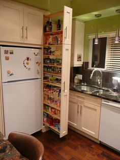 a kitchen filled with appliances and lots of cupboard space next to a counter top oven