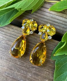 "14k Yellow Gold Plated Citrine & Clear Colored Paste Rhinestone Earrings Up for offer is a stunning pair of quality costume 14k yellow gold plated citrine and clear colored crystal paste rhinestone cluster teardrop earrings.  The stones are a high quality crystal paste with a vibrant gemstone color, and a beautiful sparkle.  These earrings would make a perfect compliment to any holiday outfit!  Earrings are not marked. Note: I made these as part of a more affordable line of high-end costume jewelry.   Measurements Length: 1.60\" Drop Length: 1\" Width: 0.60\" Oval Citrine Rhinestones: 9.5mm x 8mm Small Pear Citrine Rhinestones: 8mm x 6.5mm Cushion Citrine Rhinestones: 7.5mm x 7.5mm Small Clear Rhinestones: 2.5mm Large Citrine Rhinestone Pendants: 25mm x 15mm Weight: 13 g Materials -14k Ye Luxury Statement Citrine Jewelry, Yellow Jewelry With Gemstone Accents For Formal Occasions, Formal Yellow Jewelry With Gemstone Accents, Fine Jewelry Citrine Earrings For Wedding, Yellow Citrine Earrings For Wedding, Citrine Fine Jewelry Earrings For Wedding, Citrine Wedding Earrings Fine Jewelry, Gold Teardrop Earrings With Stones, Citrine Drop Earrings For Wedding