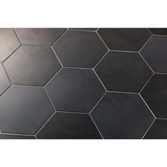 a black and white tiled floor with hexagonal tiles on the bottom, top