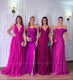 three women in purple dresses standing next to each other