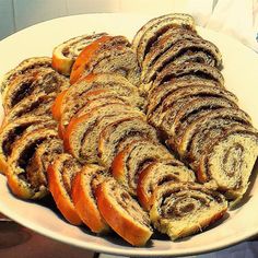 a white plate topped with slices of cinnamon roll