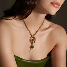 The Finian Necklace from our Lucresia Collection is truly stunning. This gorgeous necklace is made from 24K gold electroplated brass with green and purple Czech glass stones and a Majorcan glass pearl drop. It fastens with a lobster claw closure and has a 2" extender chain. The necklace measures 15.5" in length. Made to order in our New York City design studio; please allow 7-14 business days for production before the ship date. Fall Necklaces, Formal Necklace, Vintage Statement Jewelry, Prom Inspiration, Necklace Stack, Large Pendant Necklace, Big Necklace, Long Statement Necklace, Tiktok Shop