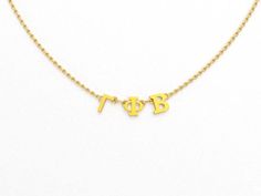 a gold necklace with the letters b and f on it