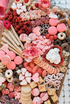 a tray filled with lots of different types of cookies and pastries on top of each other