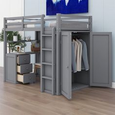 a loft bed with a desk underneath it and drawers under the bed, next to a painting on the wall