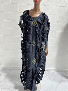 This Kaftan" is a stunning expression of bold fashion and cultural elegance, handmade in Ghana. Crafted with vibrant fabric in a variety of colors, this unique dress features intricate cut-out patterns that create a flowing, airy design. It also comes in a stylish jeans fabric. Not stitched on the sides, this kaftan offers a free-flowing fit perfect for making a statement. Ideal for both casual and formal occasions, its loose, comfortable fit is complemented by artistic geometric accents, adding a touch of sophistication and cultural flair. Pair it with your favorite accessories to complete a look that is both eye-catching and effortlessly chic. one size it’s all Black Bohemian Dress With Traditional Patterns, Bohemian Party Dresses With Traditional Patterns, Summer Fitted Dresses With Woven Motifs, Fitted Summer Dresses With Woven Motifs, Summer Fitted Dresses With Traditional Patterns, Traditional Patchwork Dress For Summer, Multicolor Dresses With Traditional Patterns For Summer, Multicolor Summer Dresses With Traditional Patterns, Fitted Traditional Maxi Dress For Beach