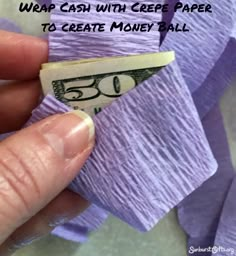 someone is holding a roll of purple paper with money sticking out of it and the words wrap cash with crepe paper to create money ball