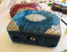 a blue velvet box sitting on top of a table