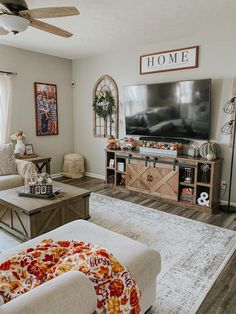 a living room filled with furniture and a flat screen tv on top of a wooden stand