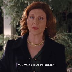 an older woman wearing a black jacket and gold necklace with the words you wear that in public