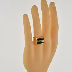 Vintage 14K Yellow Gold Black Onyx and Diamond Ring, 1/2 ct diamond, 2 flat panels of black onyx flank, 6 round channel set diamonds, Ring size 11, Circa 1960, 9.3 grams SKU # BB262R04 Most rings are sizable for a small fee. If the ring you are considering is the incorrect size contact us for a quote. This listing contains photographs of the actual item you will receive. Our items are in excellent condition with little or no signs of wear and many are one of a kind pre-owned estate finds. Please Black Channel Set Rings For Anniversary, Anniversary Black Channel Set Rings, Black Modernist Jewelry For Anniversary, Formal Gold Diamond Ring With Black Enamel, Classic Black Ring With 17 Jewels, Formal Yellow Gold Diamond Ring With Black Enamel, Black Formal Rings With Single Cut Diamonds, Formal Black Rings With Single Cut Diamonds, Formal Black Jewelry With Single Cut Diamonds