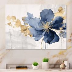 a blue and gold flower painting on a white wall next to a fireplace mantel