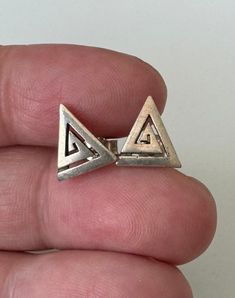 These vintage earrings from the 90s feature a distinctive triangular design and are made from high-quality 925 silver. With a height of approx. 1.1 cm and a width of approx. 1 cm, they offer a striking look that is perfect for lovers of vintage style. The earrings are stamped "925" for their silver alloy and show the charm of decades gone by. Material: 925 silver Style: Vintage Earrings Shape: Triangular Height: Approx. 1.1 cm Width: Approx. 1 cm Condition: Slightly tarnished, see pictures for details These vintage earrings from the 90s are a real statement piece for lovers of retro chic. The triangular design gives them a unique aesthetic that goes perfectly with different outfits and occasions. The light patina gives the earrings a touch of nostalgia and underlines their vintage characte Vintage Character, 925 Silver Earrings, Silver Style, Timeless Accessories, Retro Chic, Vintage Beauty, For Lovers, The 90s, Unique Charms