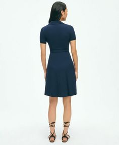 A new polo play, our wrap dress is made from butter-soft cotton modal knit in a classic pique pattern. A functional wrap silhouette, full skirt and smoothing power mesh lining make this a stylishly comfortable way to spend your spring-summer days. Featuring ribbed collar and our Golden Fleece® logo on the chest.39" center back lengthBodice fully lined with power meshSnap at bust for modesty57% Cotton, 39% Modal, 4% SpandexMachine Wash according to care instructions for best resultsImported | Women's Polo Wrap Dress in Pique Cotton Modal Blend | Navy | Size Medium Fitted Solid Polo Dress For Spring, Versatile Fitted Short Sleeve Dresses, Fitted Polo Dress For Work With Collared Neckline, Versatile Fitted Dress With Short Sleeves, Fitted Collared Dresses For Work, Fitted Dresses With Collared Neckline For Work, Fitted Wrap Dress For Work With Short Sleeves, Elegant Fitted Polo Dress For Work, Fitted Polo Dress For Spring