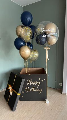 a box with balloons and a sign that says happy birthday