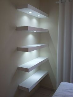 some white shelves are lit up in the corner