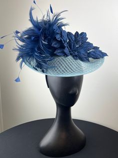 A pale blue windowpane saucer is accented with a navy feather crown and navy velvet leaves. Sits on a comfortable black headband. Lightweight and easy to wear. Ships in a high quality storage box. One of a kind.  Perfect for Kentucky Derby, Royal Ascot, church, weddings, just for fun. Feather Crown, Blue Fascinator, Navy Velvet, Black Headband, Royal Ascot, Pale Blue, Kentucky Derby, Just For Fun, Fascinator