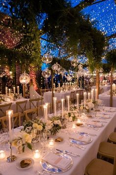 a long table is set up with candles and place settings for an elegant wedding reception