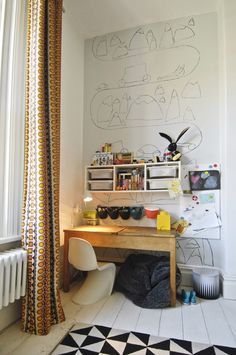 a room with a desk, chair and bookshelf next to a radiator