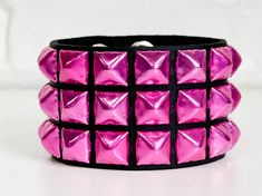 Three Row Pink 1/2" Pyramid Stud  Bracelet Genuine Cowhide 7oz Weight Leather Bracelet Snap Bracelet 7oz Cowhide Leather Military Grade Rust Protected Spikes Width-1 3/4" Wide SIZE:    ALL BRACELET ARE 9"-9 1/2" LONG.  FITS 7"-9"  WRISTS Gothic Adjustable Wristband For Parties, Adjustable Edgy Wristband For Party, Adjustable Alternative Bracelets For Party, Adjustable Alternative Style Bracelets For Party, Adjustable Rocker Bracelets For Party, Adjustable Rocker Bracelets For Parties, Adjustable Rocker Bracelet For Party, Adjustable Rocker Style Bracelets For Parties, Adjustable Rocker Style Party Bracelet